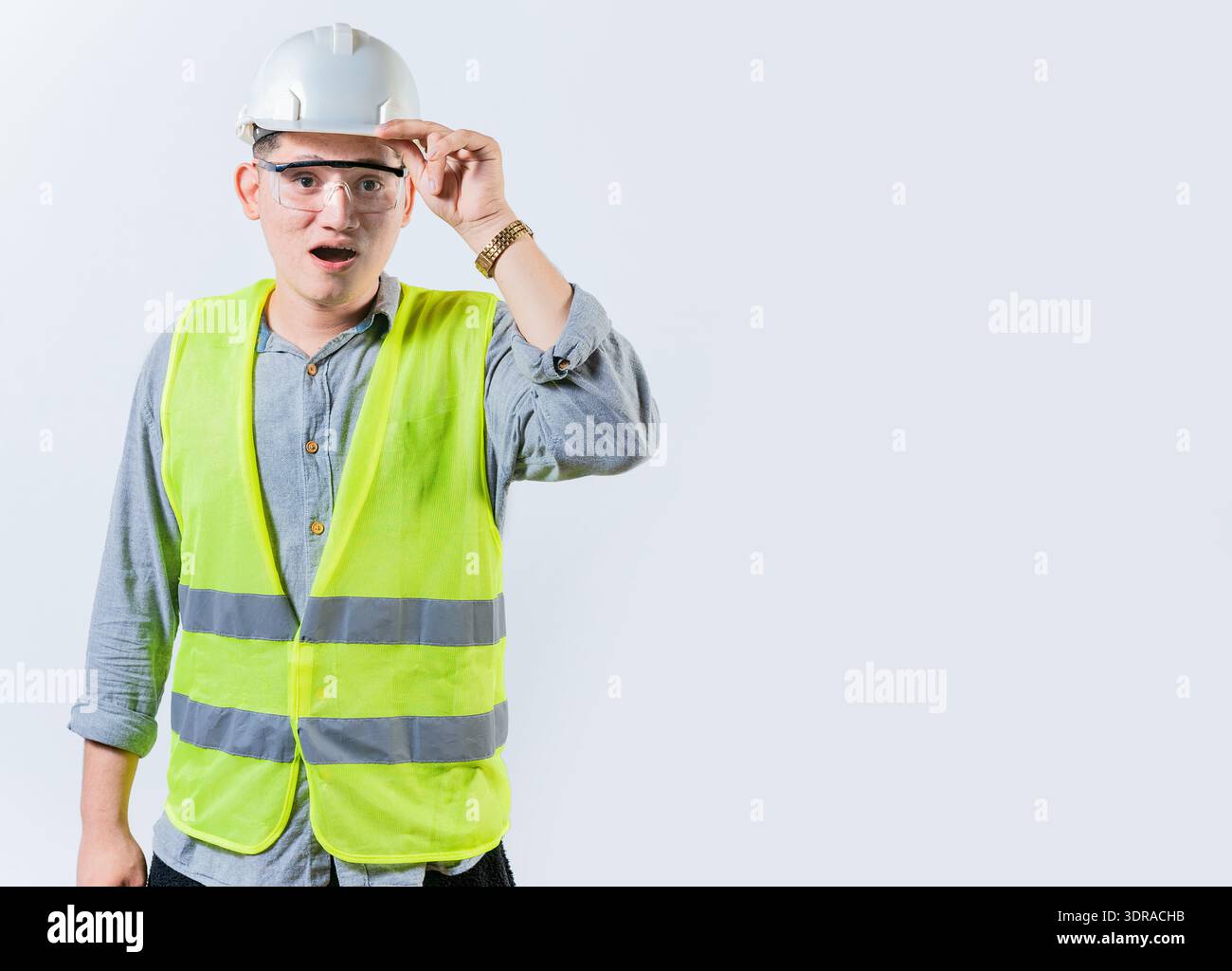 Amazed engineer looking into the distance isolated. Young engineer looking at something in the distance. Surprised man engineer Stock Photo