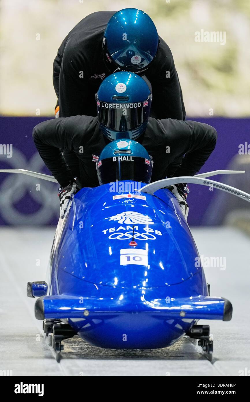 Britain's Brad Hall, front, starts for a four man bobsled training ...