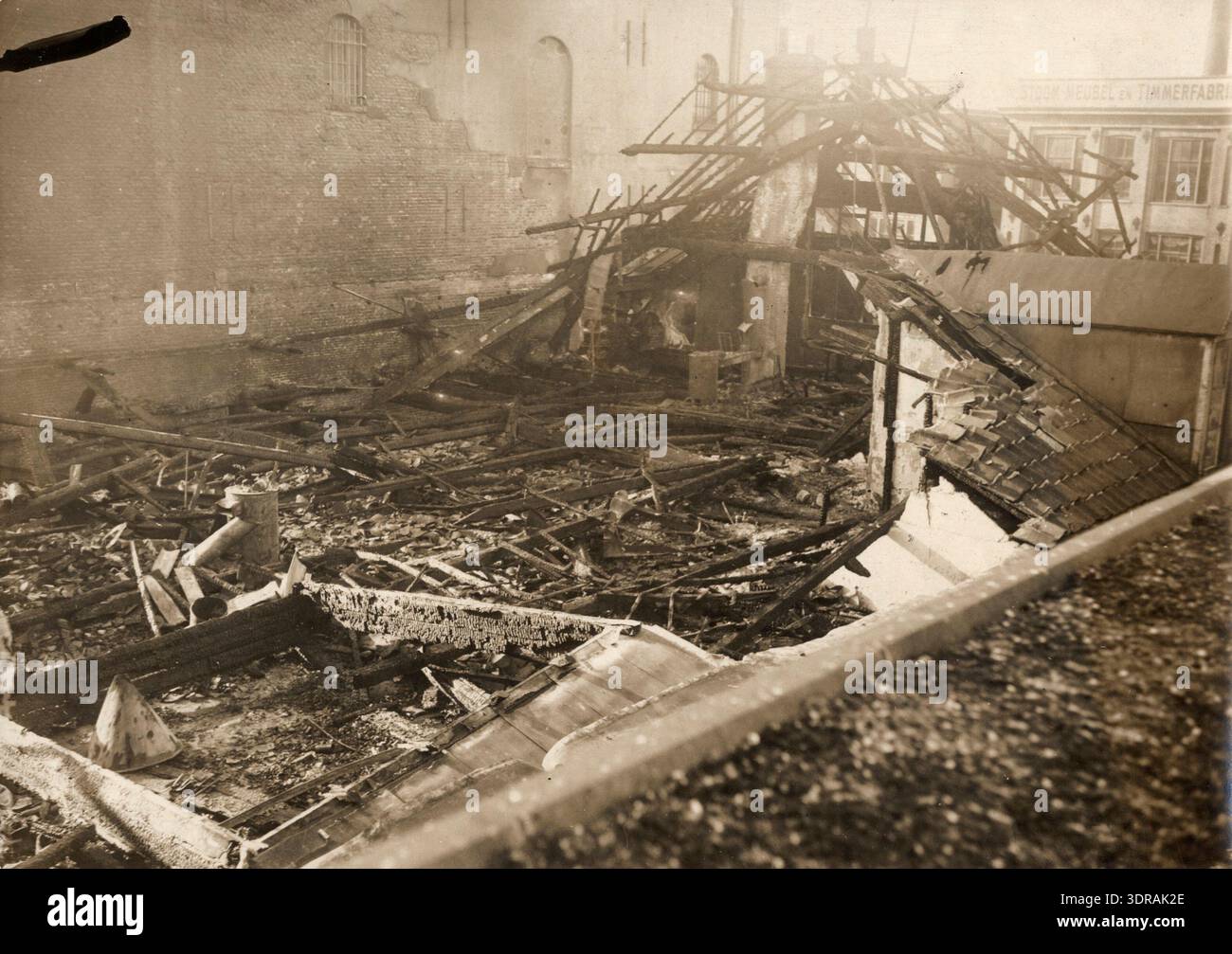 Factory Fire Aftermath The photograph shows the aftermath of a fire in a furniture factory on ...
