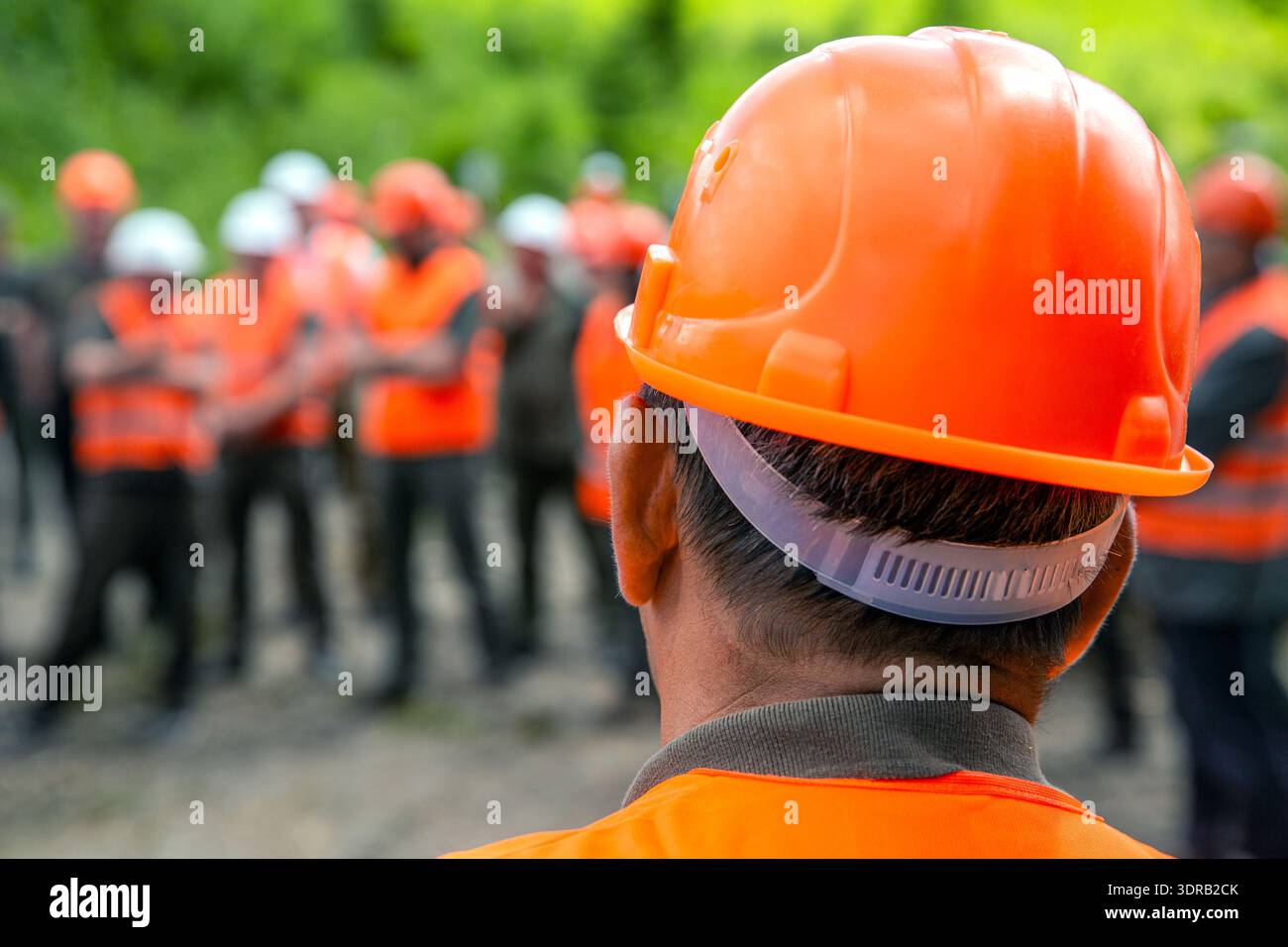 Building concept. Architector, engineers on constructing site. Helmet builder. Many construction workers helmet. Engineer team in hardhat for work Stock Photo