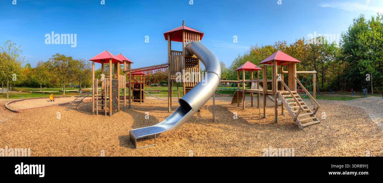 Wooden climbing castle with towers, palisades, slides, ropes and ...