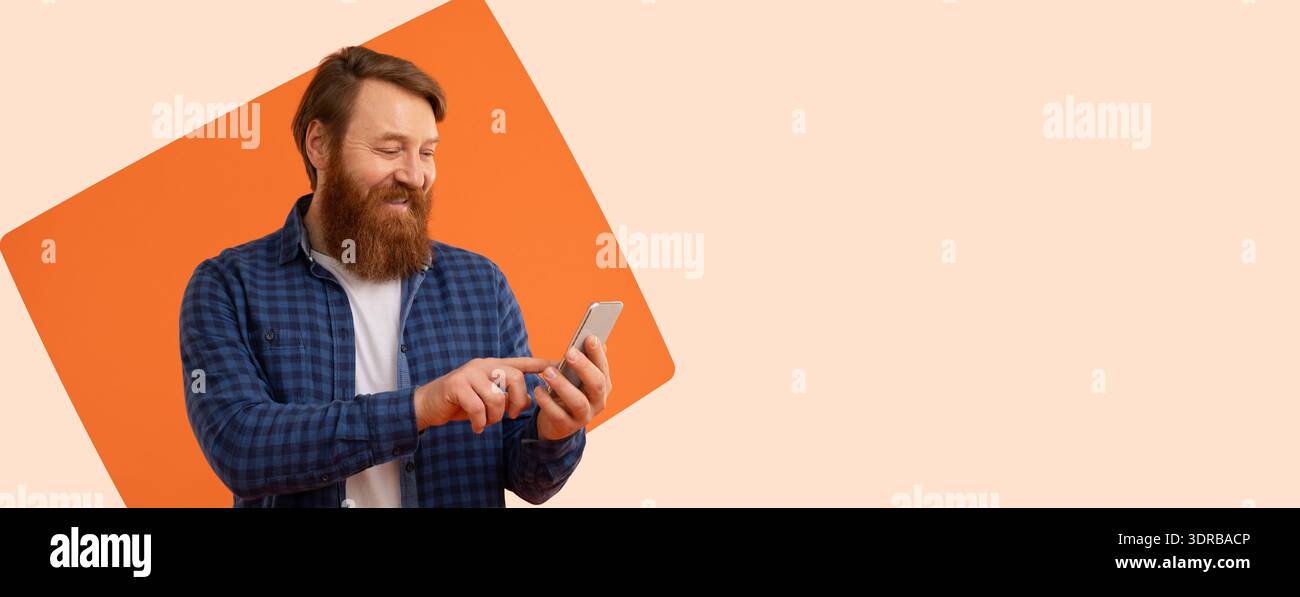 Man Using Smartphone While Standing Against a Plain Background With Shapes Stock Photo