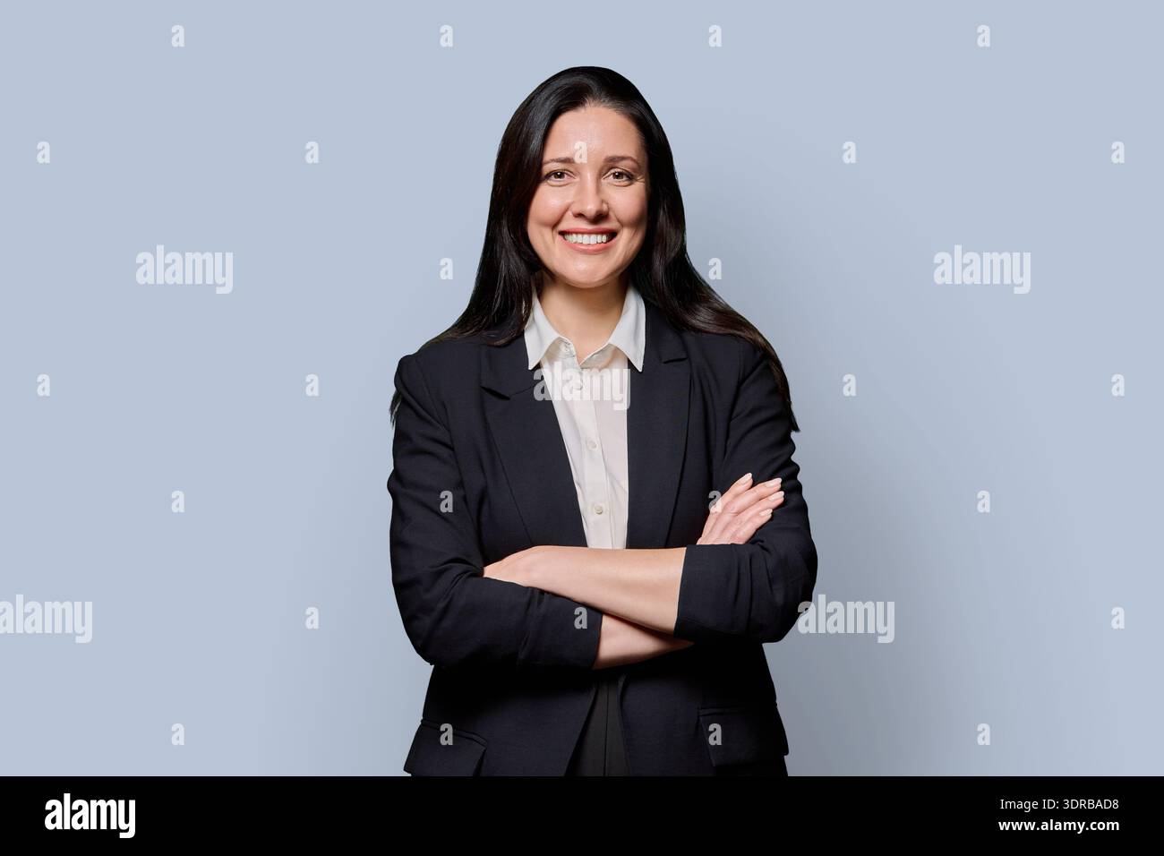 Confident successful middle-aged businesswoman in black jacket on grey studio background Stock Photo
