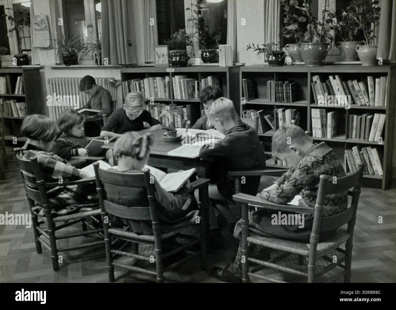 This photograph depicts children reading at tables in the childr hi-res ...