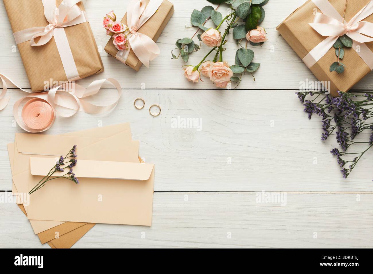 Collection of Gifts, Flowers, and Envelopes on a Wooden Table for a Special Event Stock Photo