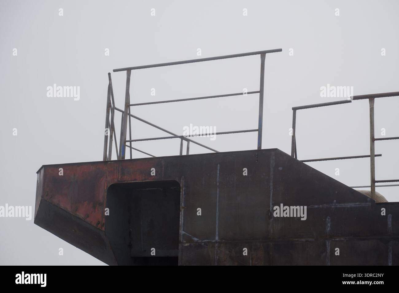 Overhung Ship Railing The metal side of a ship under construction with protective railings ...