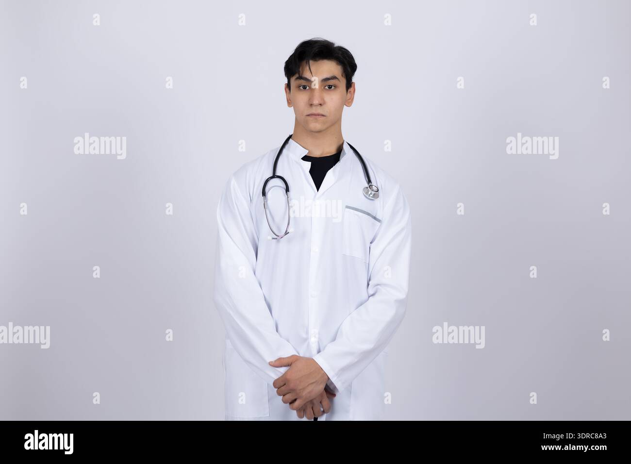Professional doctor in white medical coat posing in studio Stock Photo