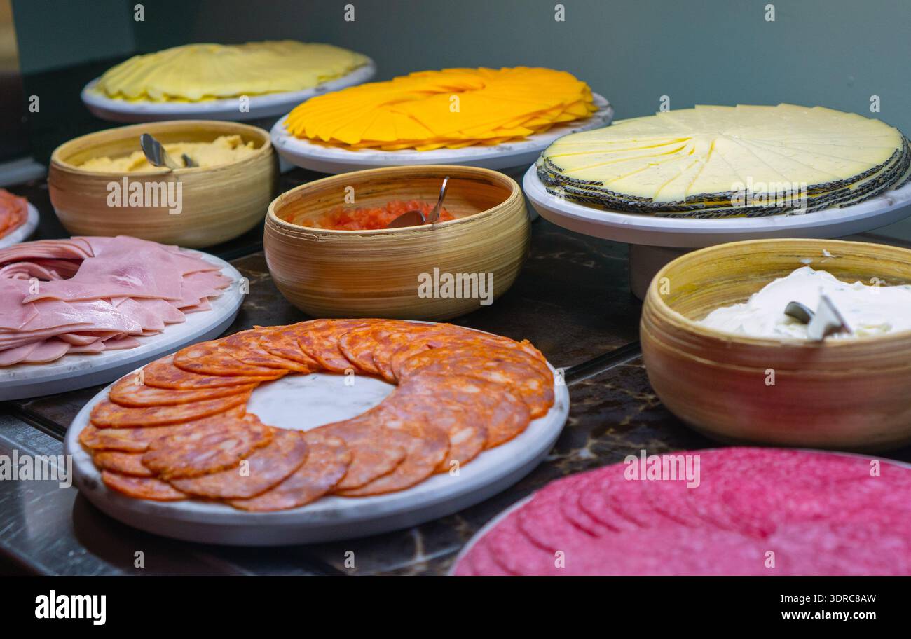 Assorted sliced cheese and cold meat cuts. Stock Photo