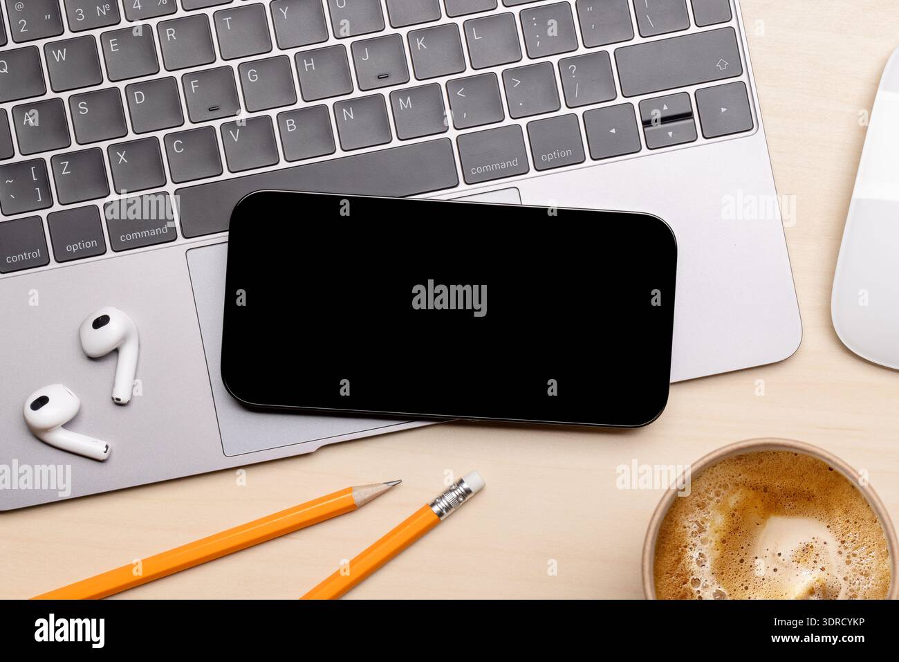 A smartphone with a black screen placed on an office table Stock Photo