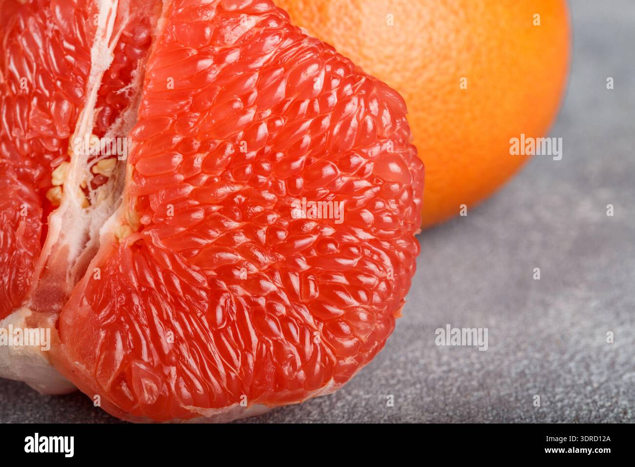 Juicy grapefruit close up on the gray stone table. Selective focus Stock Photo