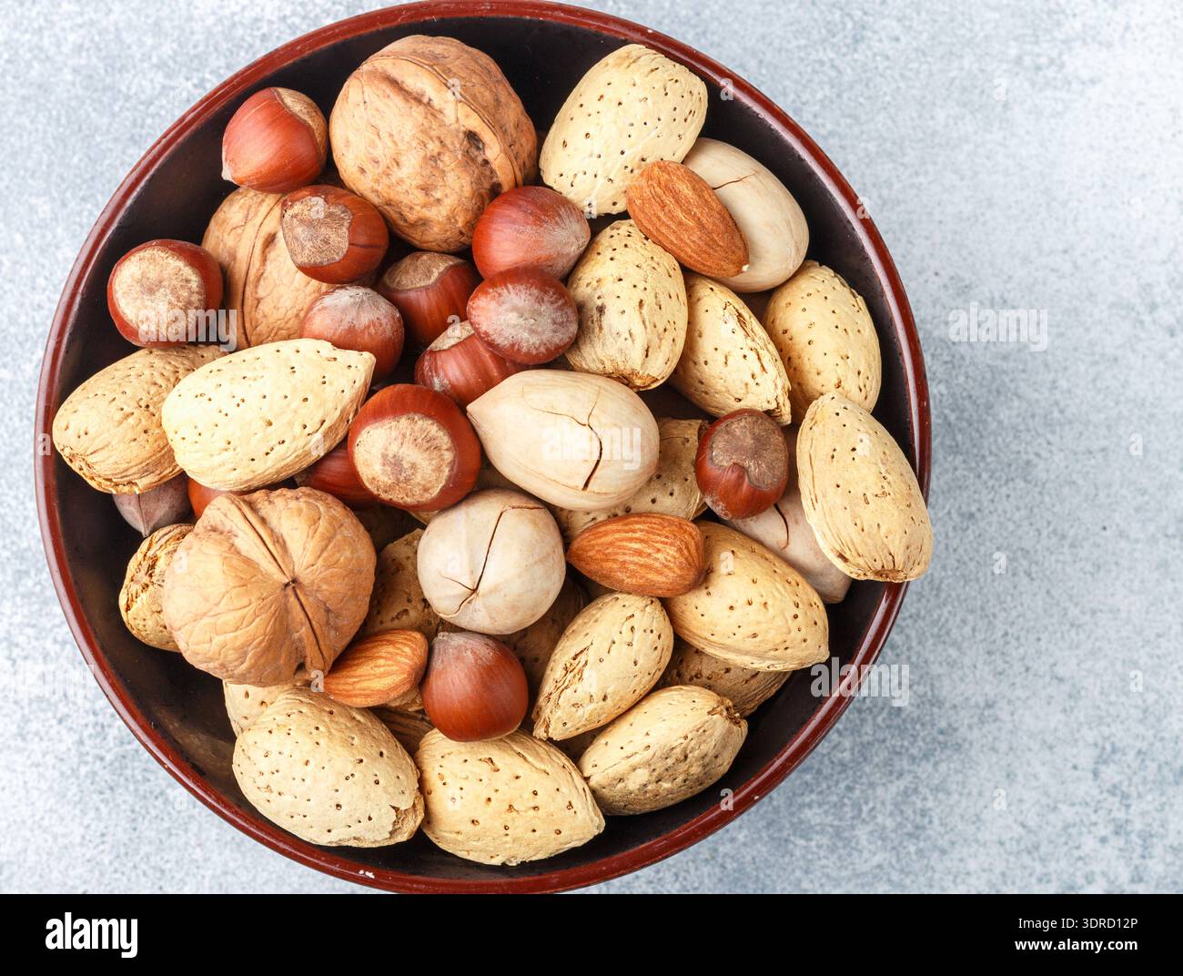 Assorted nuts in the peel-almonds, hazelnuts, pecans, walnuts Stock Photo