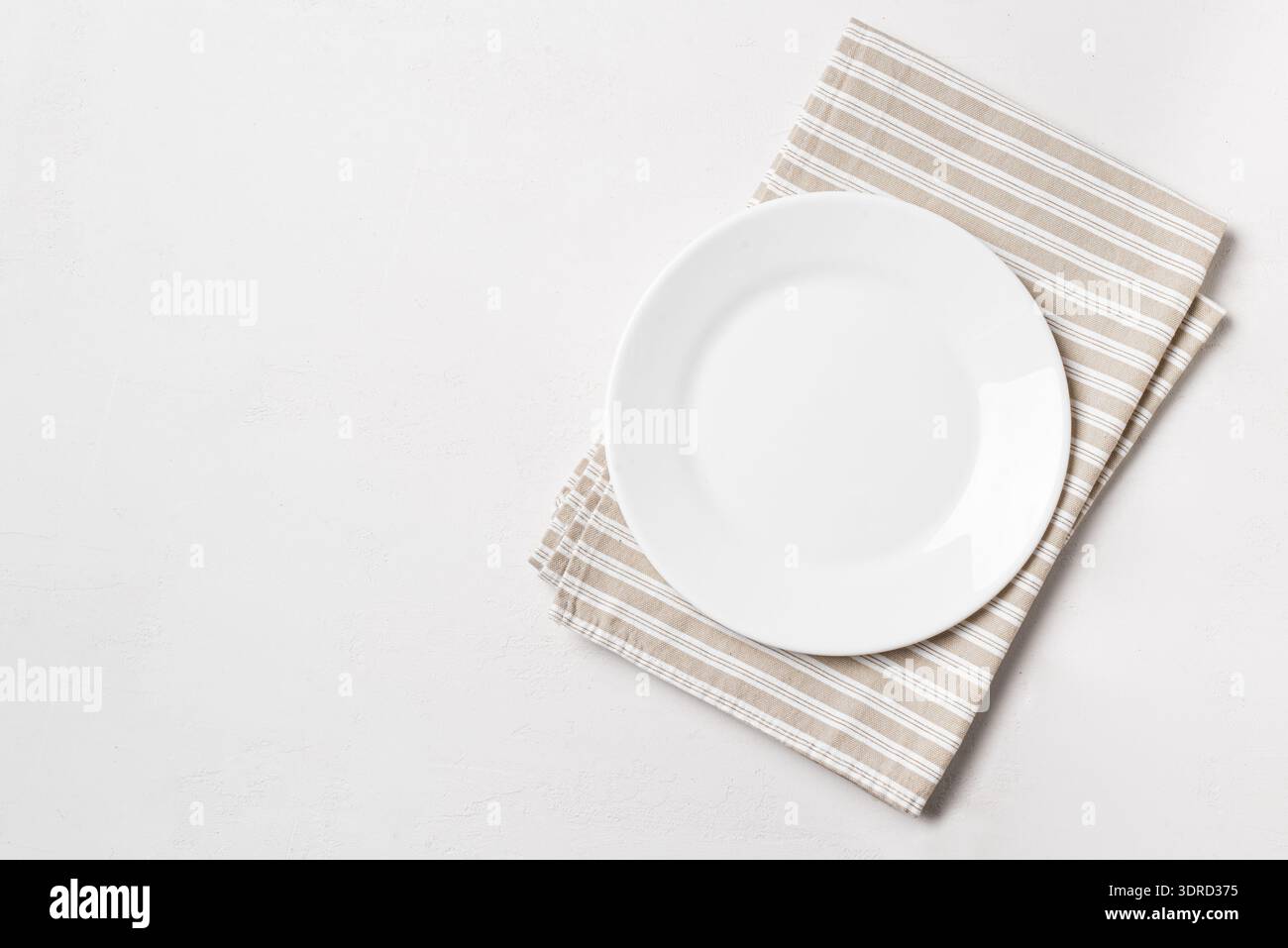 Empty plate with napkin on white background Stock Photo