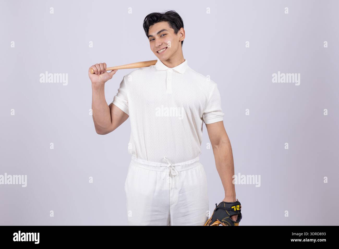 Young man holding a baseball bat on his shoulder Stock Photo