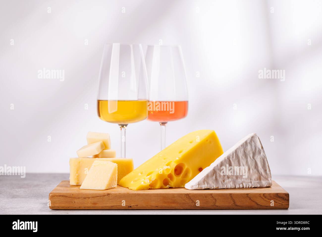 A delectable arrangement of various cheeses and wine Stock Photo