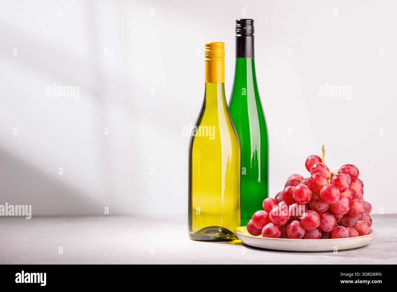 A delectable arrangement of various wine and grapes Stock Photo
