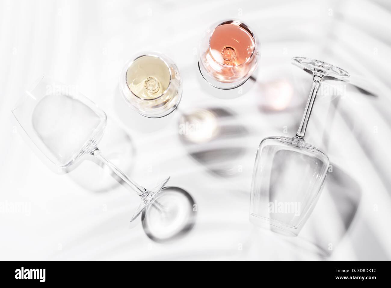 Two wine glasses filled with rose and white wine Stock Photo