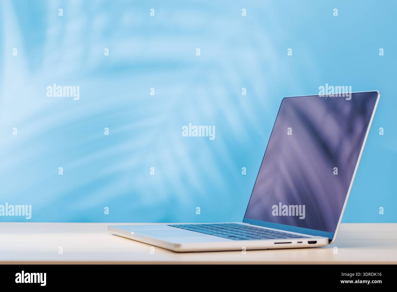 Laptop with a blank screen placed on a table Stock Photo