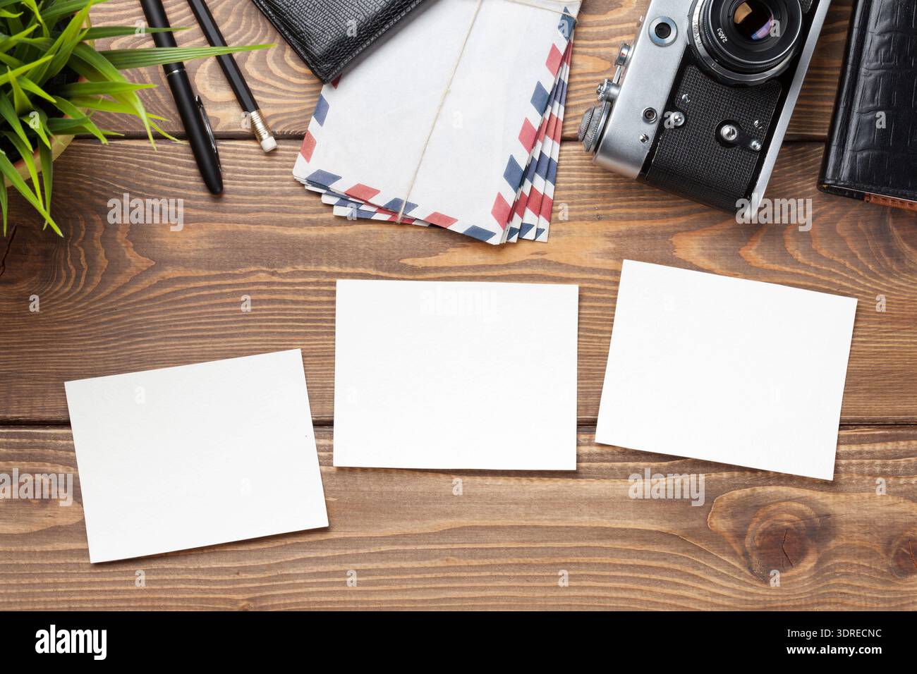 Blank photo frames, camera and supplies on table Stock Photo