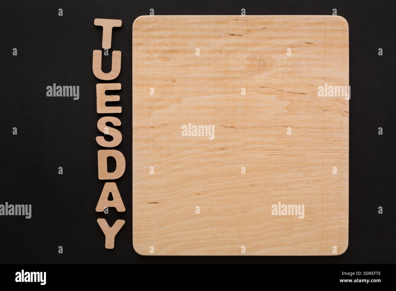 Tuesday Letters Definition Wooden Board With Letters Spelling Tuesday on a Black Background at a ...