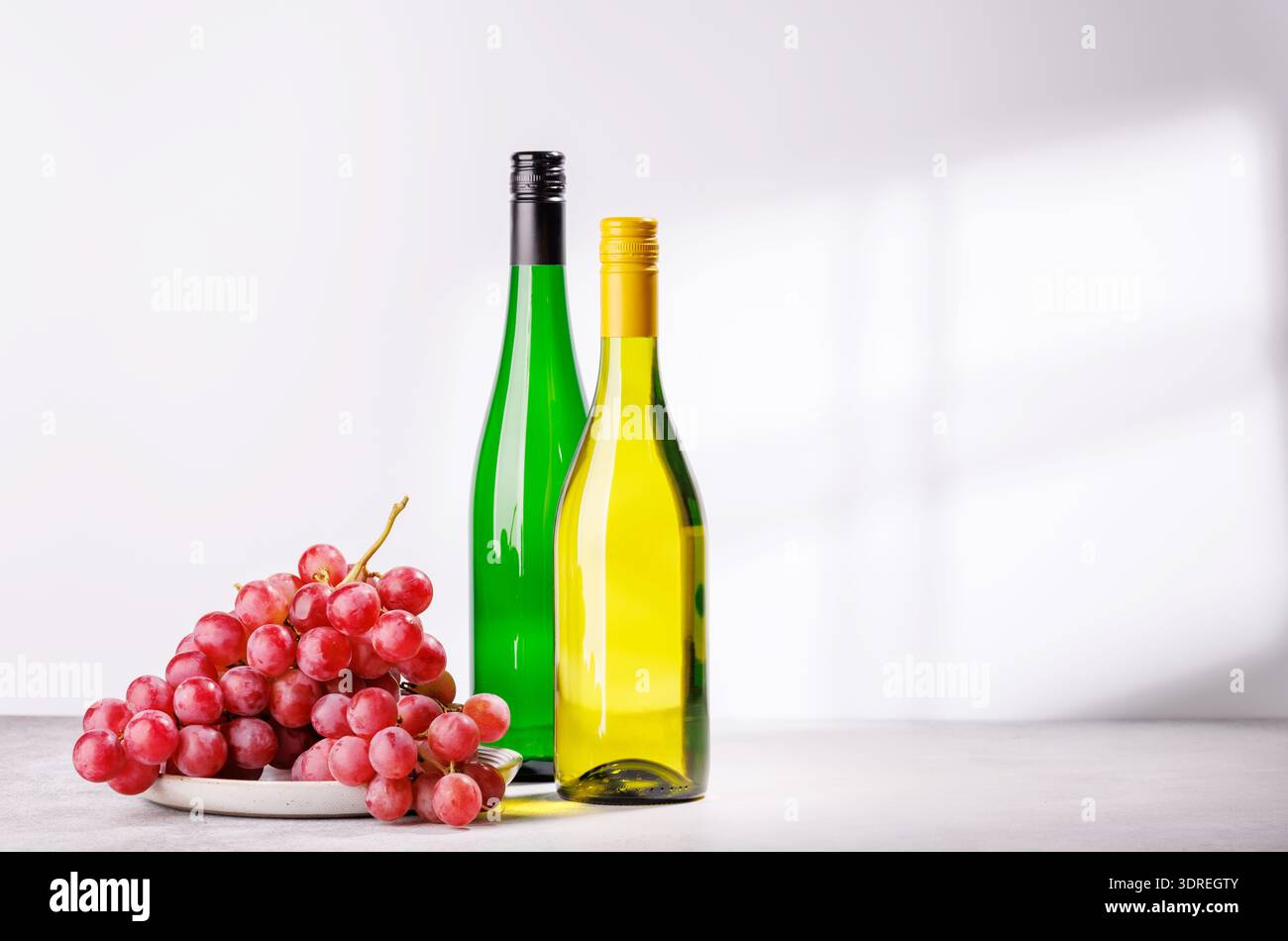 A delectable arrangement of various wine and grapes Stock Photo