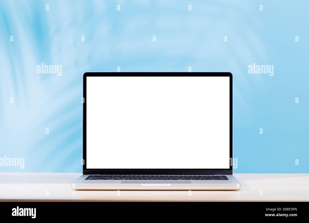 Laptop with a blank screen placed on a table Stock Photo