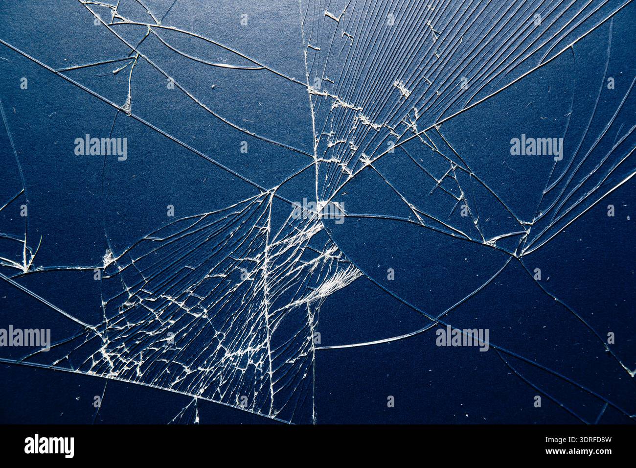 Fractured Smartphone Surface: Sharp Glass Shards and Web-Like Damage texture Stock Photo