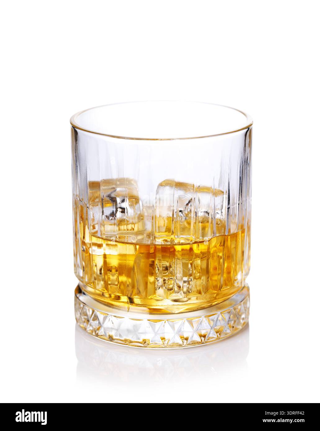 A classic whiskey glass filled with golden amber whiskey Stock Photo