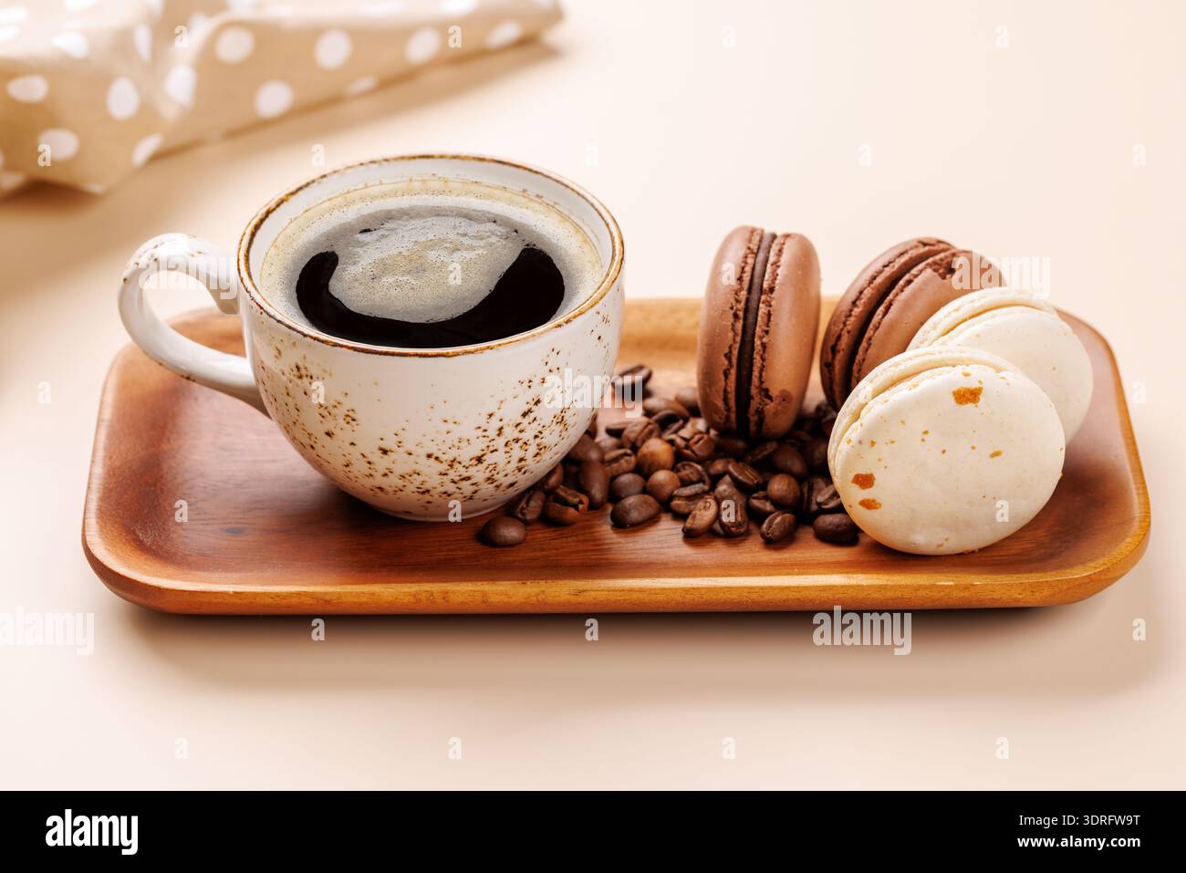 Coffee cup and macaroons on a beige background Stock Photo