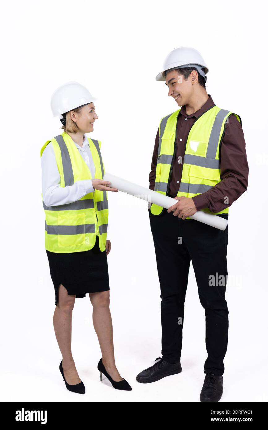 Two engineers discussing a project with blueprints Stock Photo