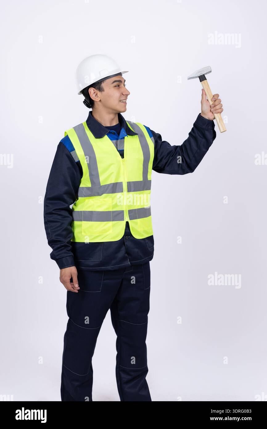 Builder measuring a wall with a metal level tool Stock Photo