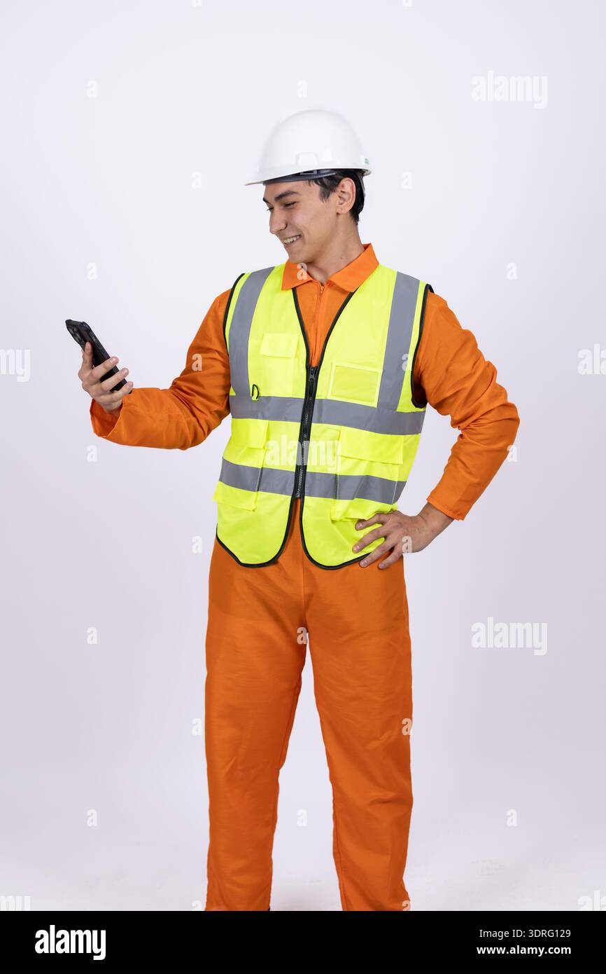 Worker in safety vest using a walkie talkie Stock Photo