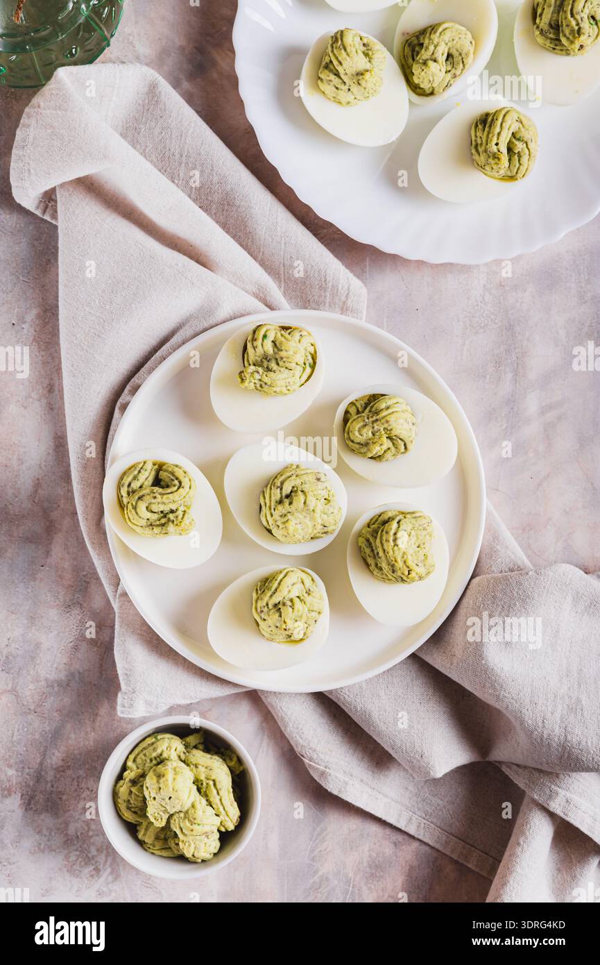 Avocado deviled eggs for appetizer on plate on table top and vertical view Stock Photo