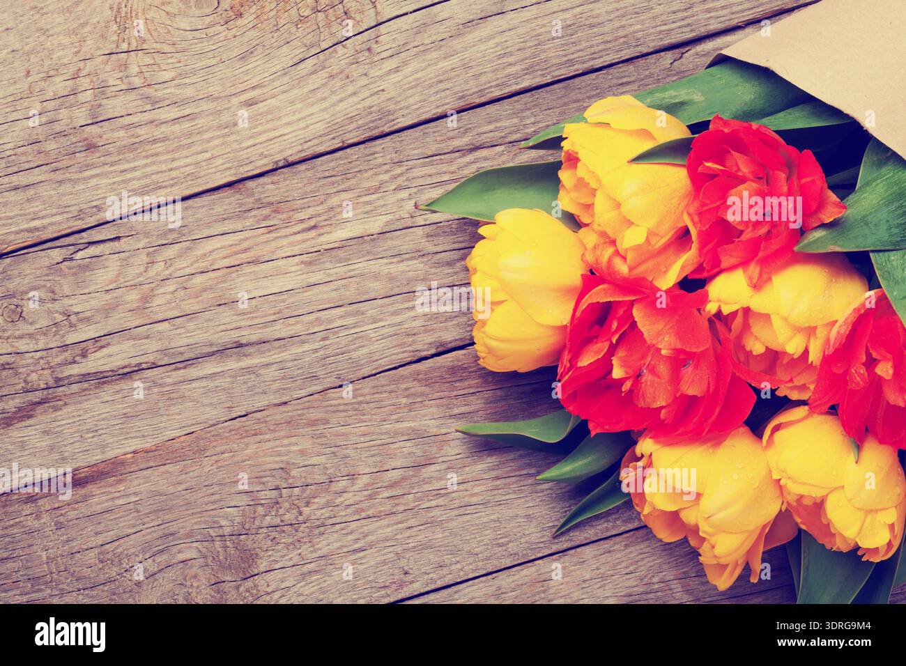 Colorful tulips over wooden table Stock Photo