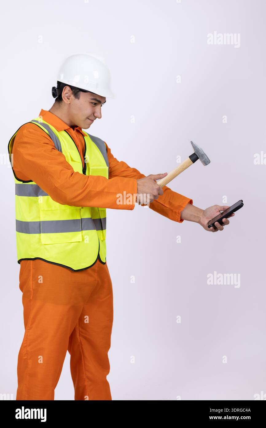 Construction worker using a hammer and a level Stock Photo