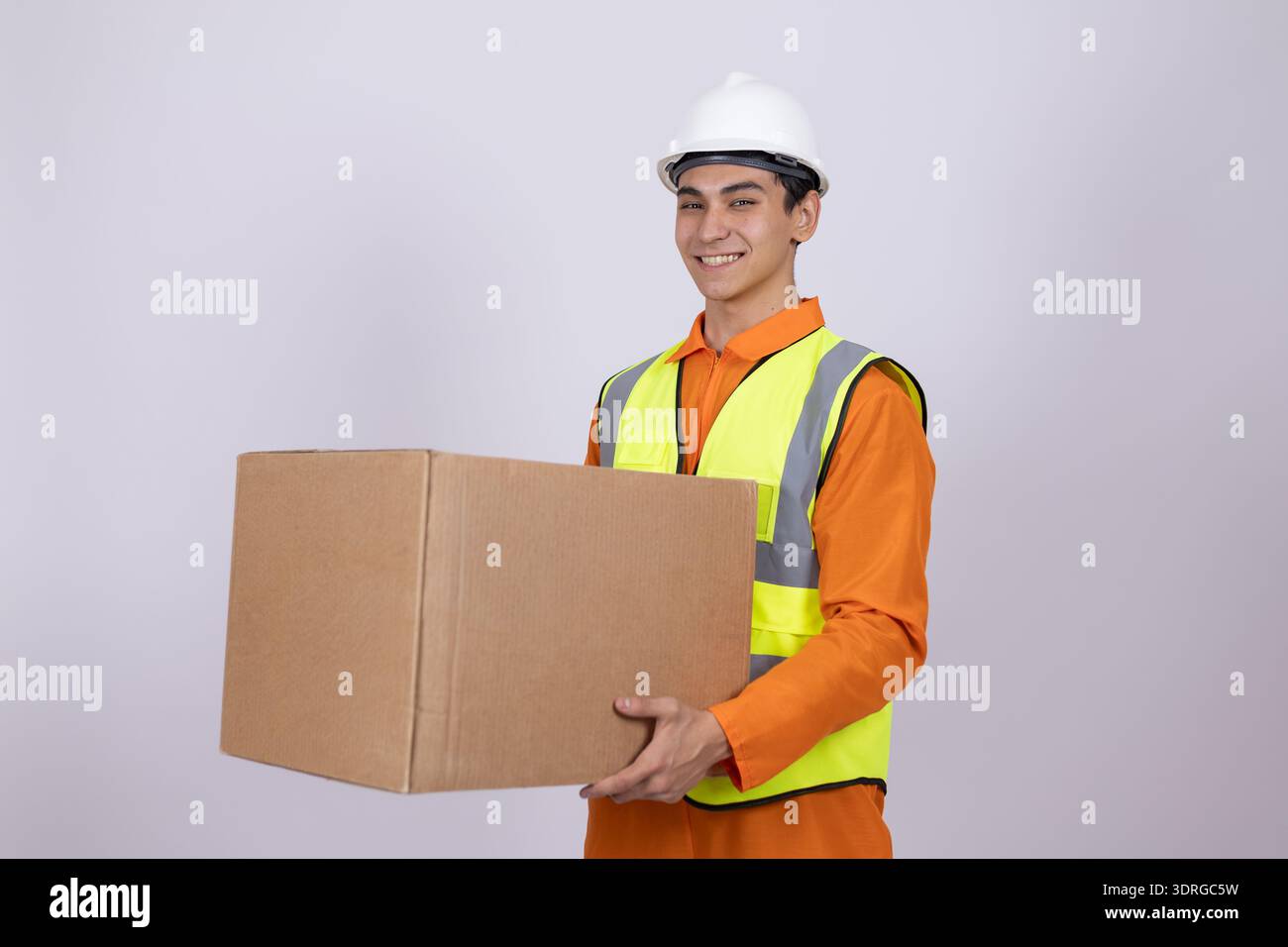 Courier holding a parcel and looking at camera Stock Photo