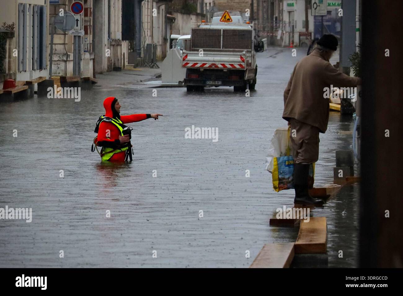 A rescue worker stands in a flooded street of Saintes as severe ...