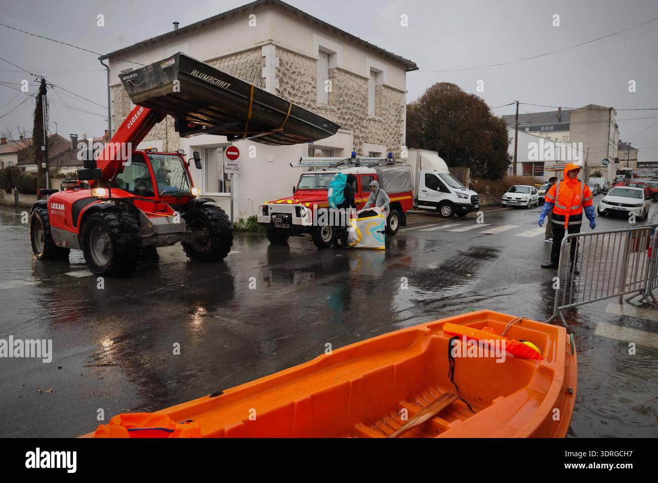Members of the rescue team work near a flooded street of Saintes as ...
