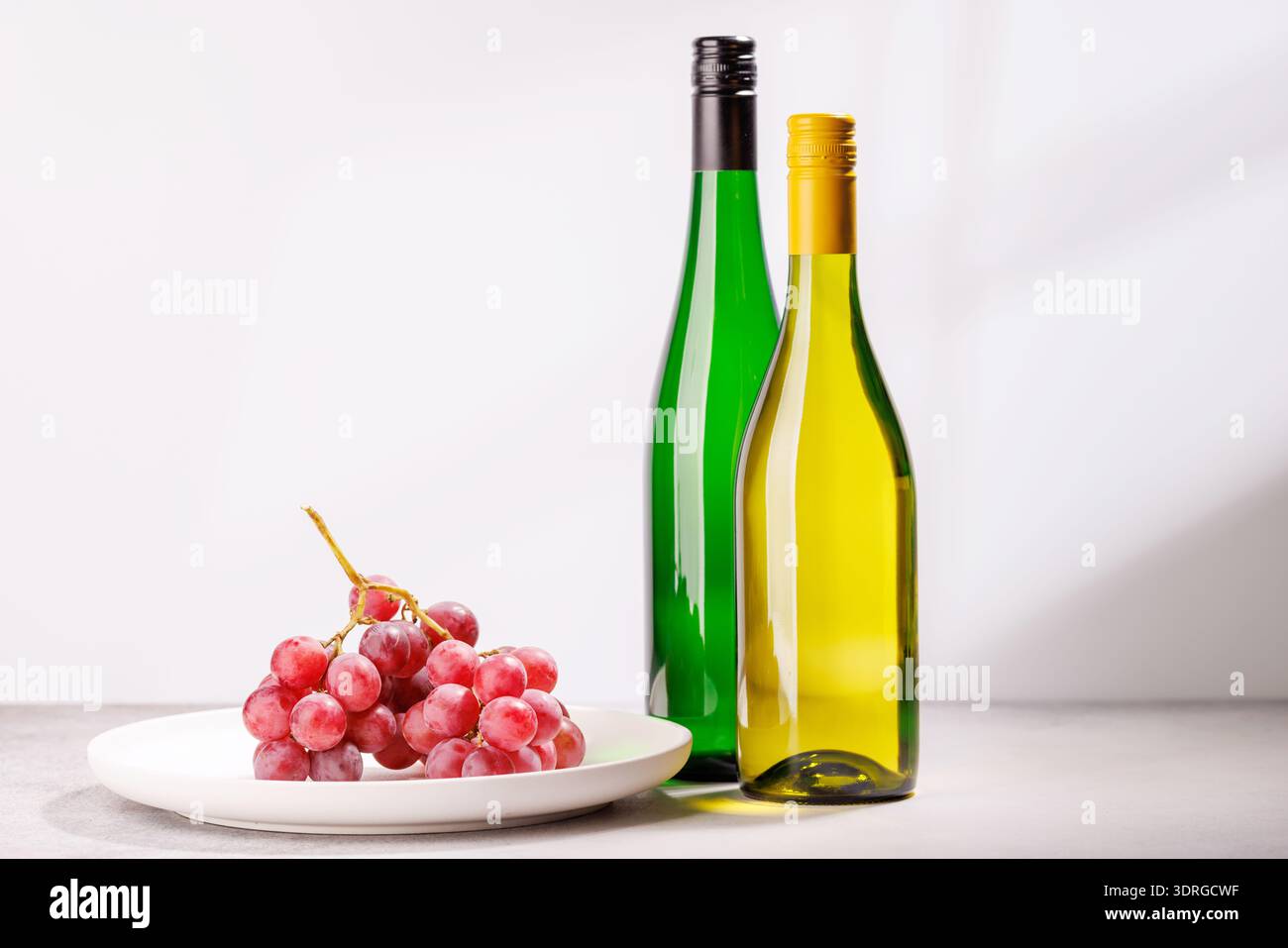 A delectable arrangement of various wine and grapes Stock Photo