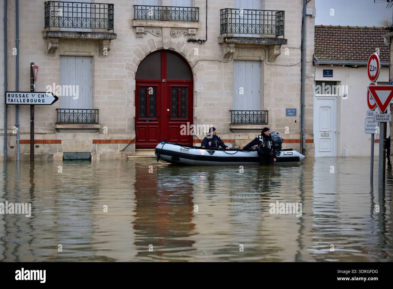 Police officers stand in a flooded street of Saintes as severe flooding ...