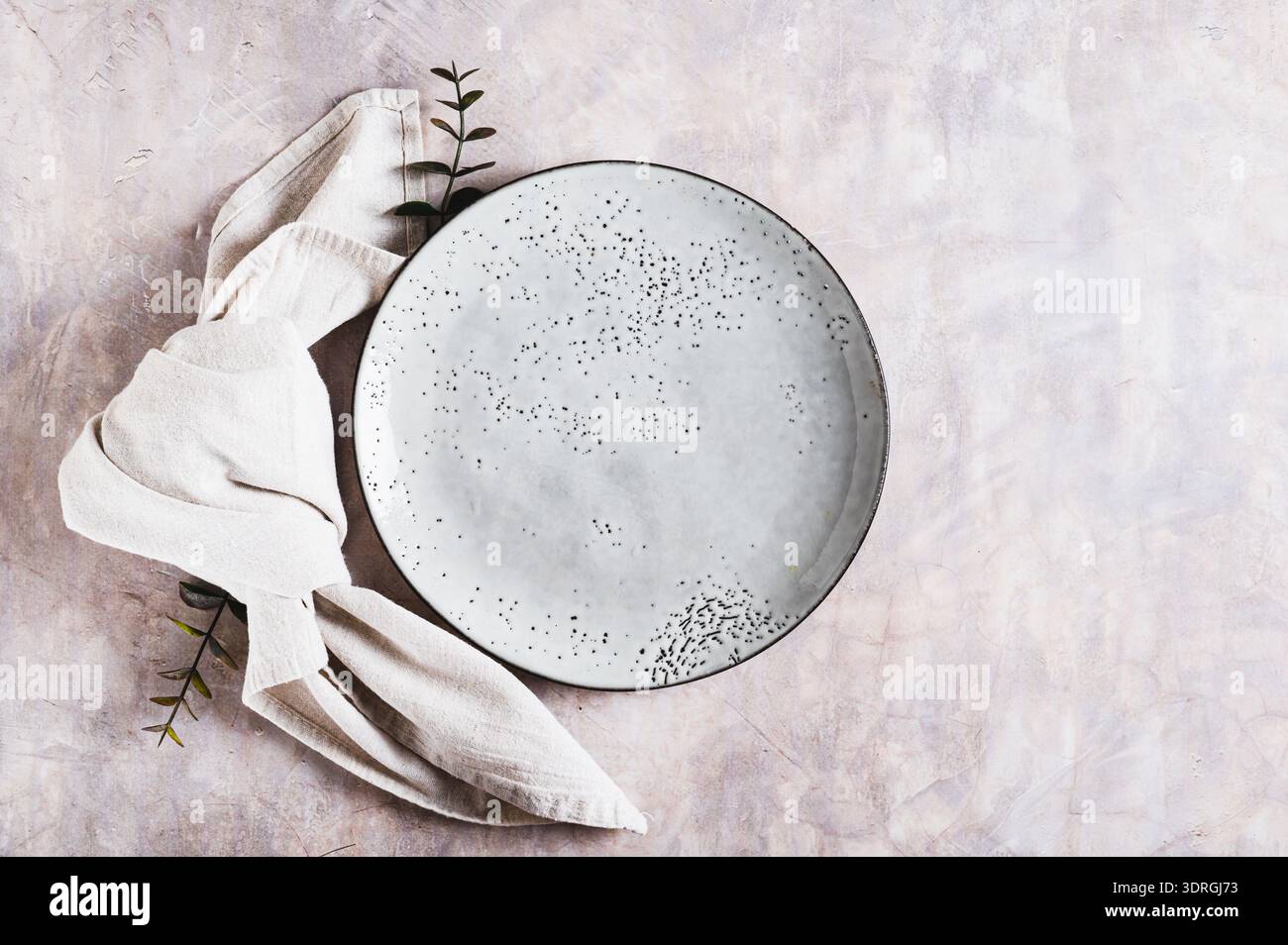 Empty gray ceramic plate and napkin on light background top view Stock Photo