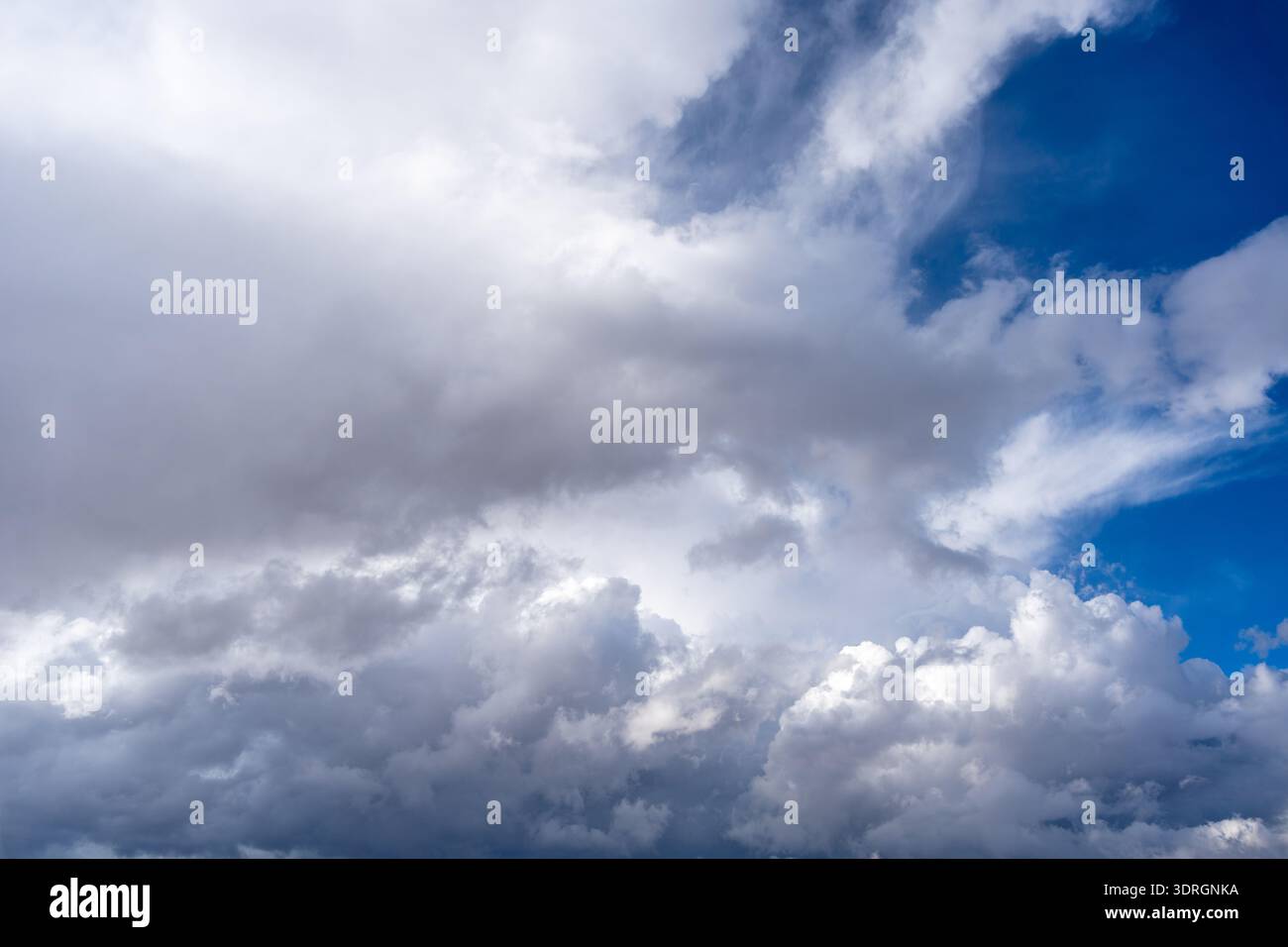 Dark storm clouds with patches of blue sky visible Stock Photo