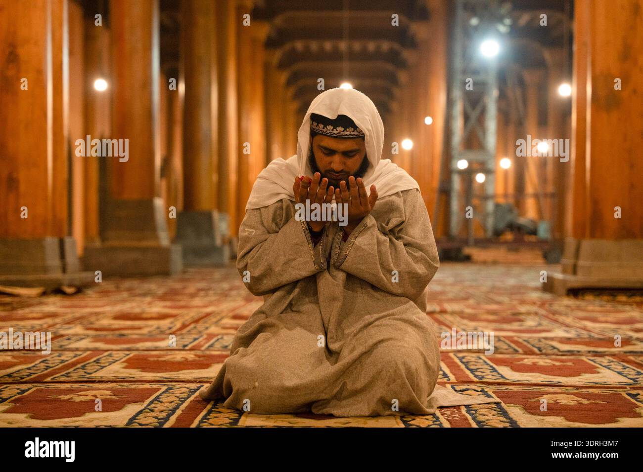 A Kashmiri Muslim man prays before performing the first Tarawih prayers ...