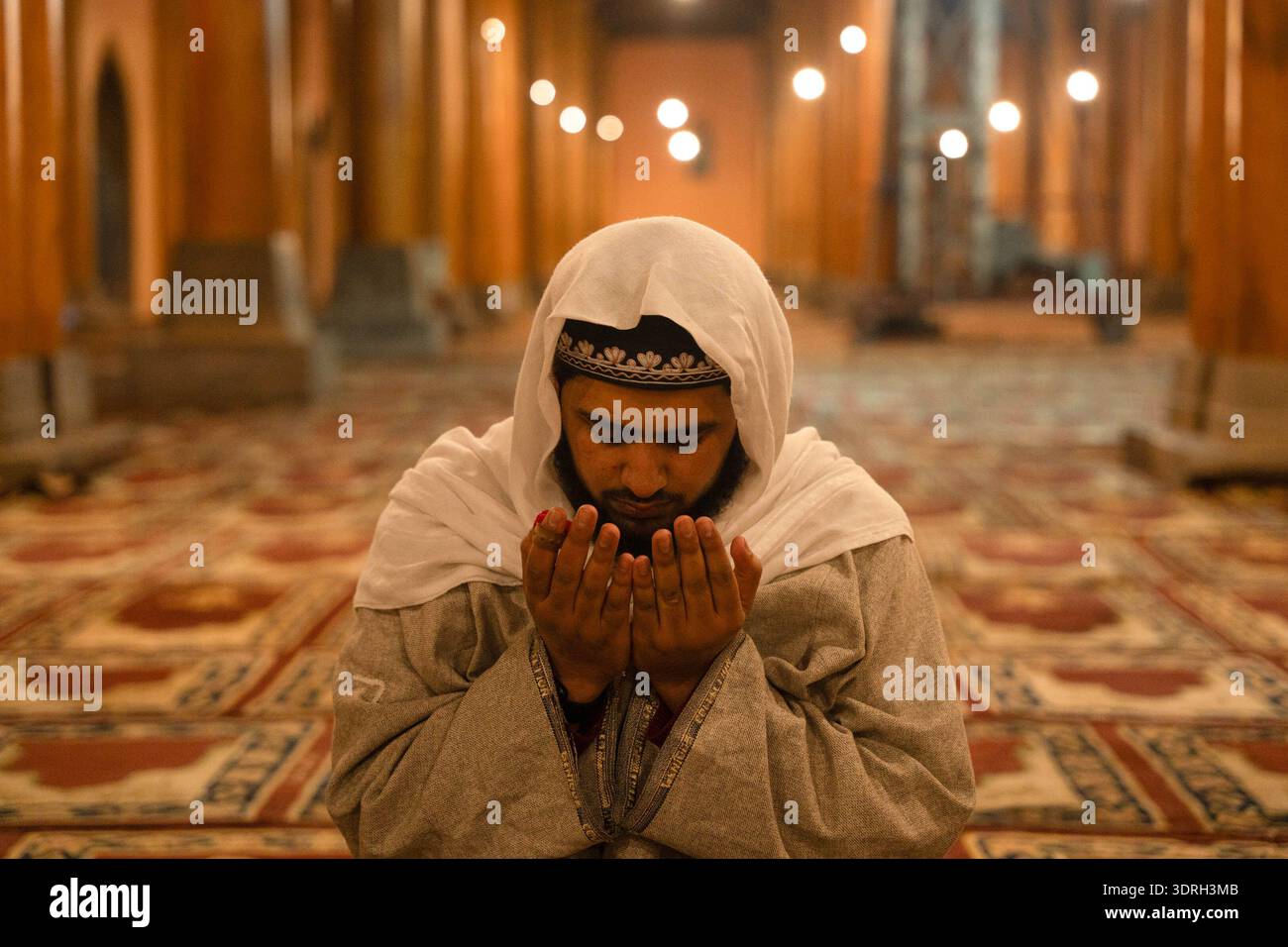 A Kashmiri Muslim man prays before performing the first Tarawih prayers ...