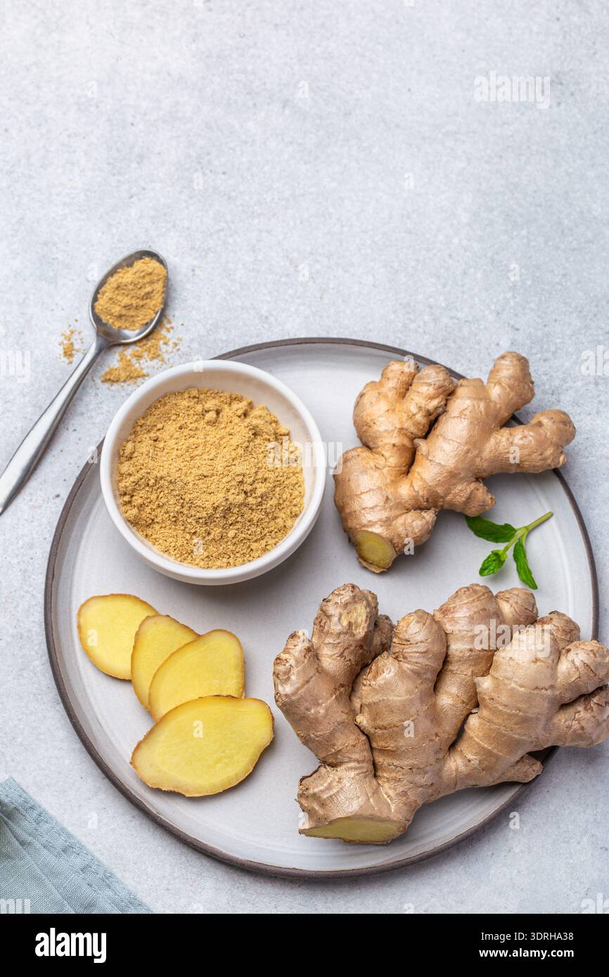 Fresh ginger root and  ginger powder  on plate, top view Stock Photo
