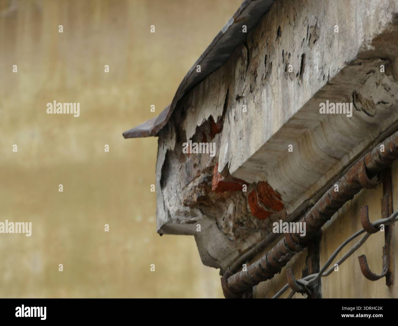 Peeling plaster and exposed brick on old building facade Stock Photo