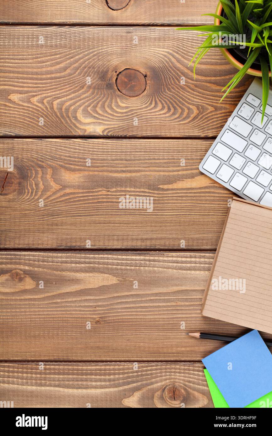 Office desk table with computer, supplies and flower Stock Photo
