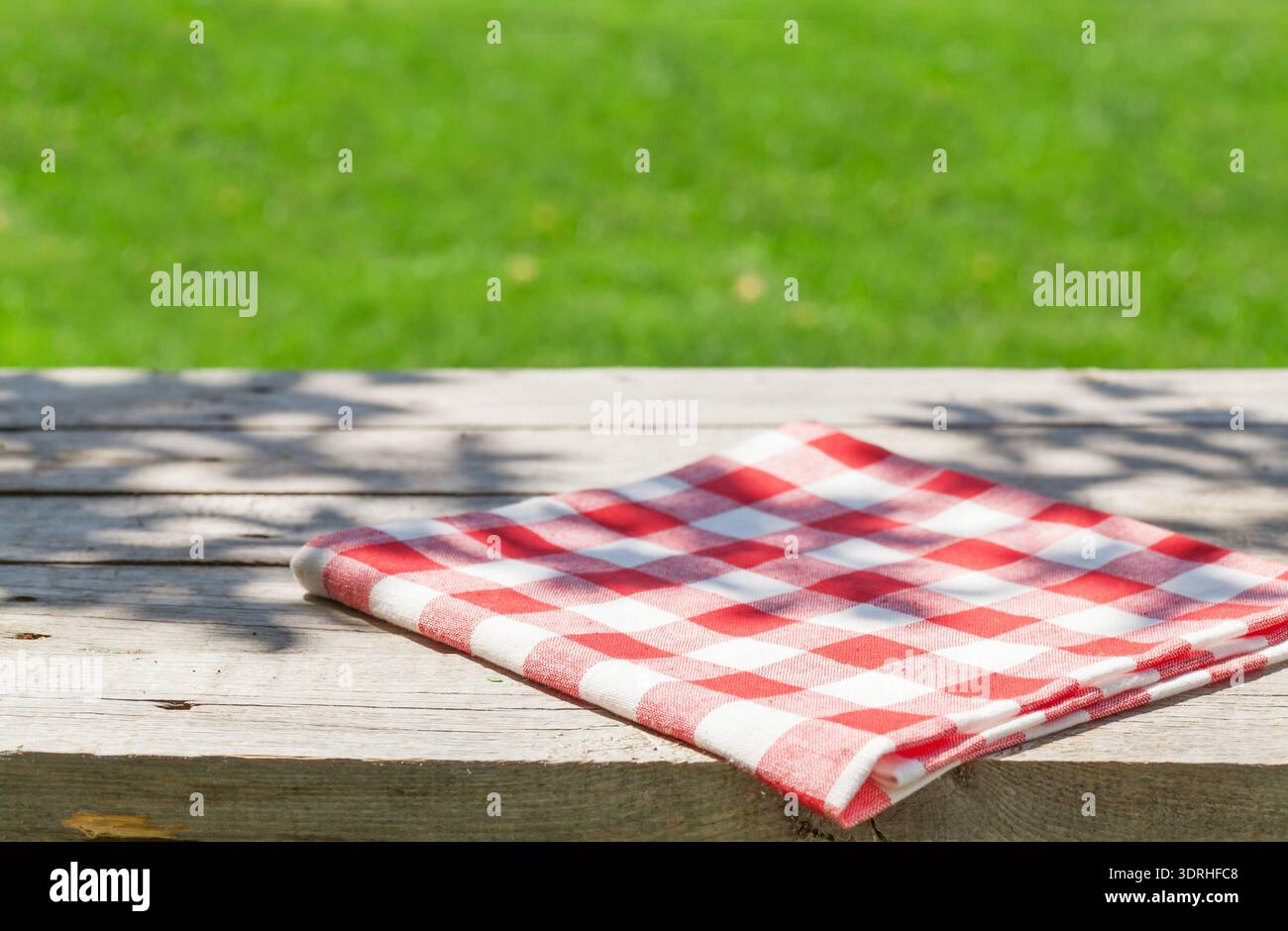 Empty wooden garden table with tablecloth Stock Photo