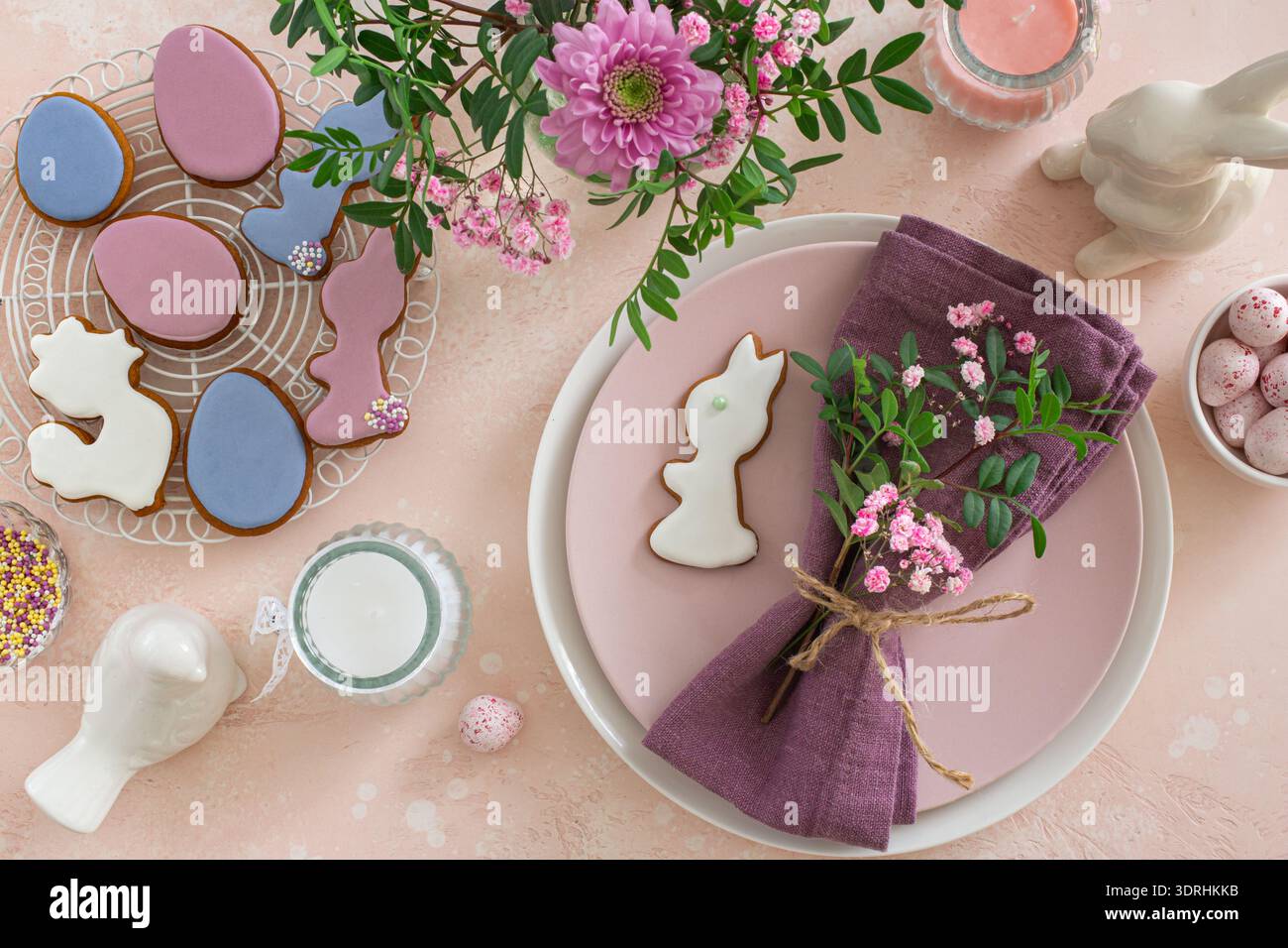 Easter table setting with flowers and icing cookies Stock Photo