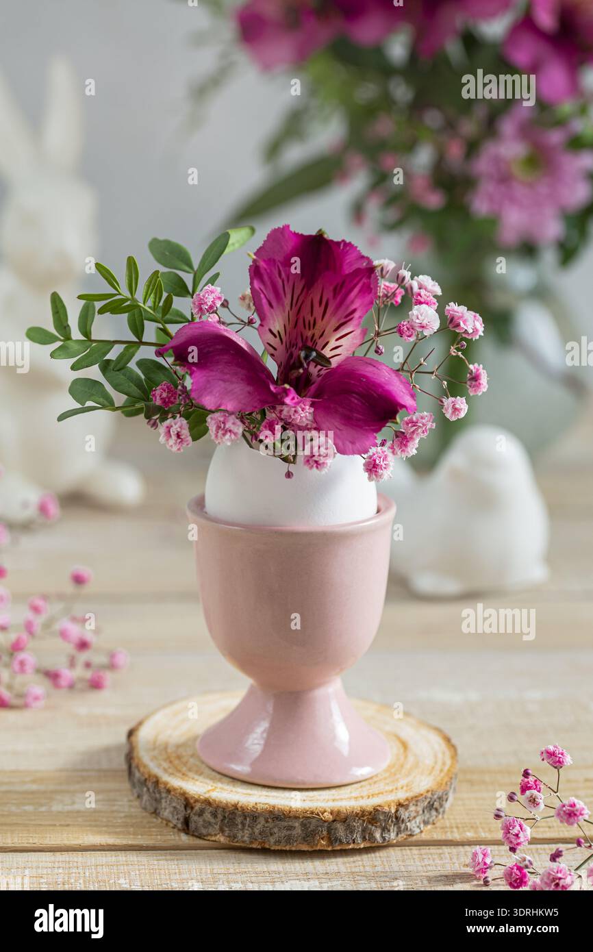 Flowers in eggshell vase. Stock Photo