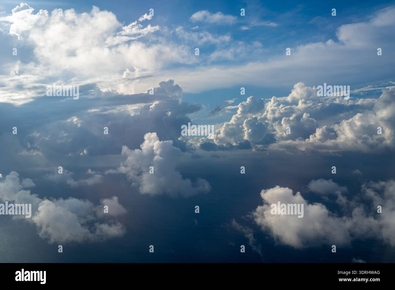 Dramatic sky with sunbeams and clouds seen from an airplane Stock Photo